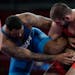 United State's Gable Dan Steveson, left, competes against Georgia's Gennadij Cudinovic during their men's freestyle 125kg wrestling final match at the