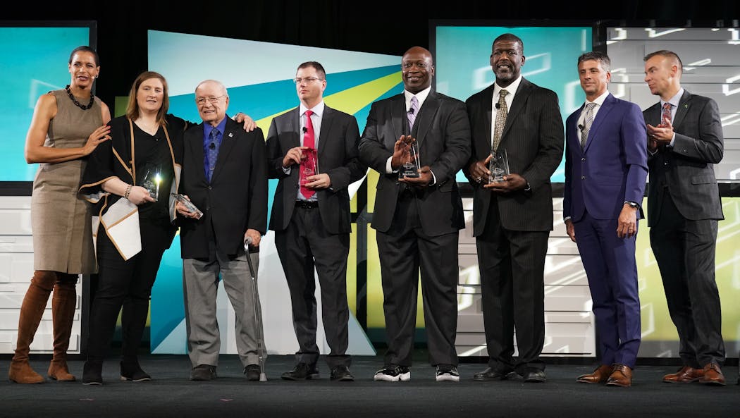 (From left) Host Lea B. Olson, Lindsay Whalen, Willard Ikola, Jim Gagliardi, John Randle, Randall McDaniel, host Anthony LaPanta and Star Tribune sports editor Chris Carr stood on the stage at the end of the Hall of Fame ceremony.