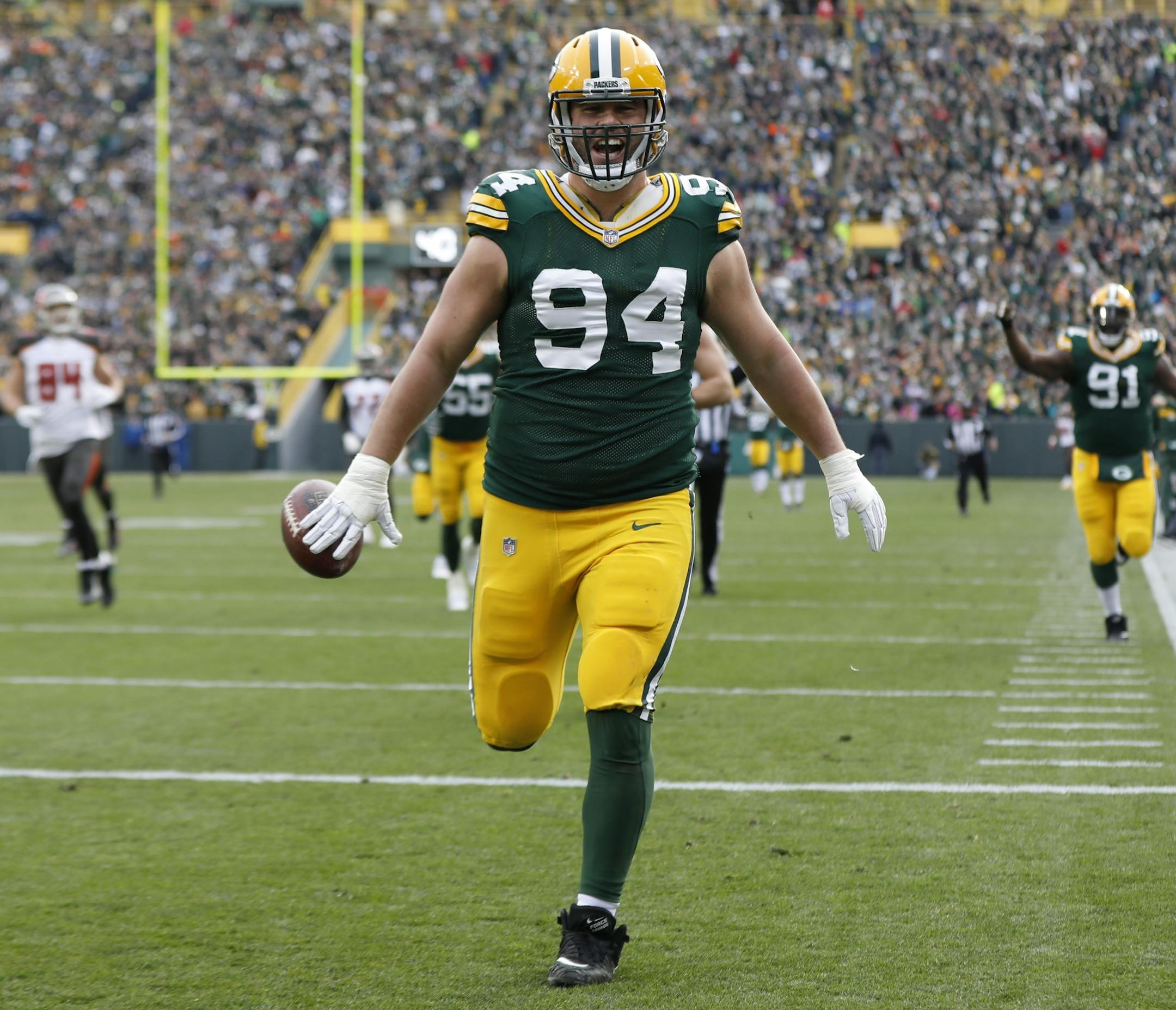 Green Bay Packers' Dean Lowry runs back a fumble recovery for a touchdown during the first half of an NFL football game against the Tampa Bay Buccaneers Sunday, Dec. 3, 2017, in Green Bay, Wis. (AP Photo/Mike Roemer)