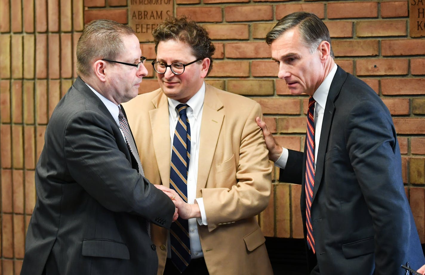 Steve Hunegs, center, executive director of the Jewish Community Relations Council, thanked FBI agent Richard Thornton, left, and Greg Brooker, acting U.S. attorney for Minnesota, after Wednesday's news conference.