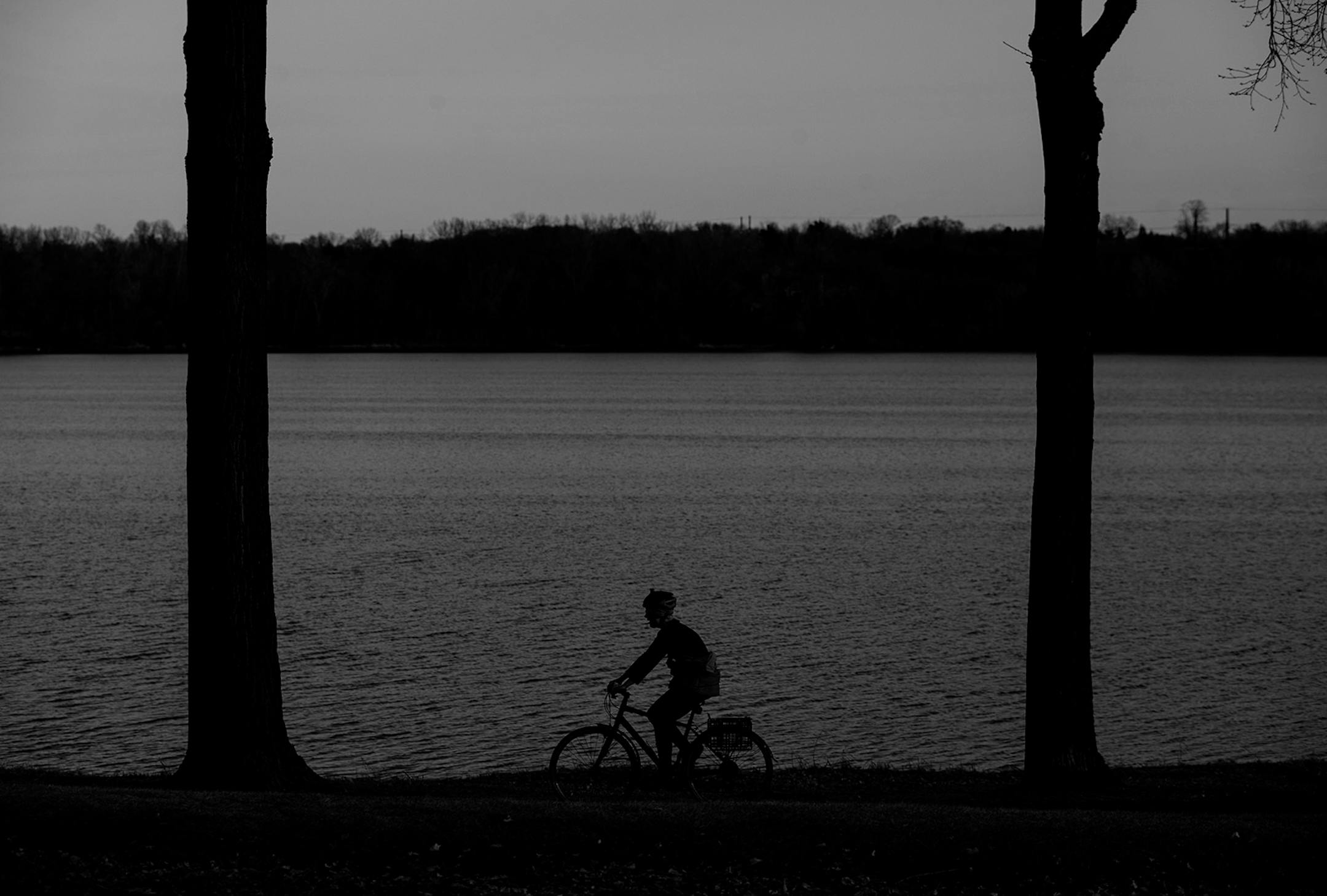 A cyclist rode on a trail by Parkers Lake in Plymouth, Minn.
