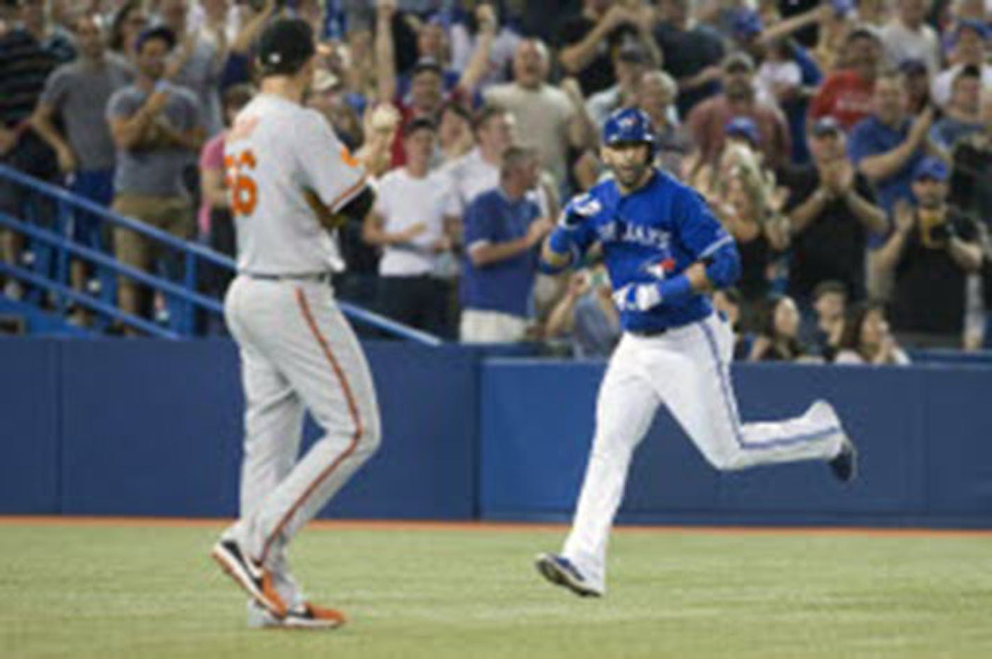 The Blue Jays' Jose Bautista, right, gestured to Orioles pitcher Darren O'Day after hitting a home run during the eighth inning Saturday.