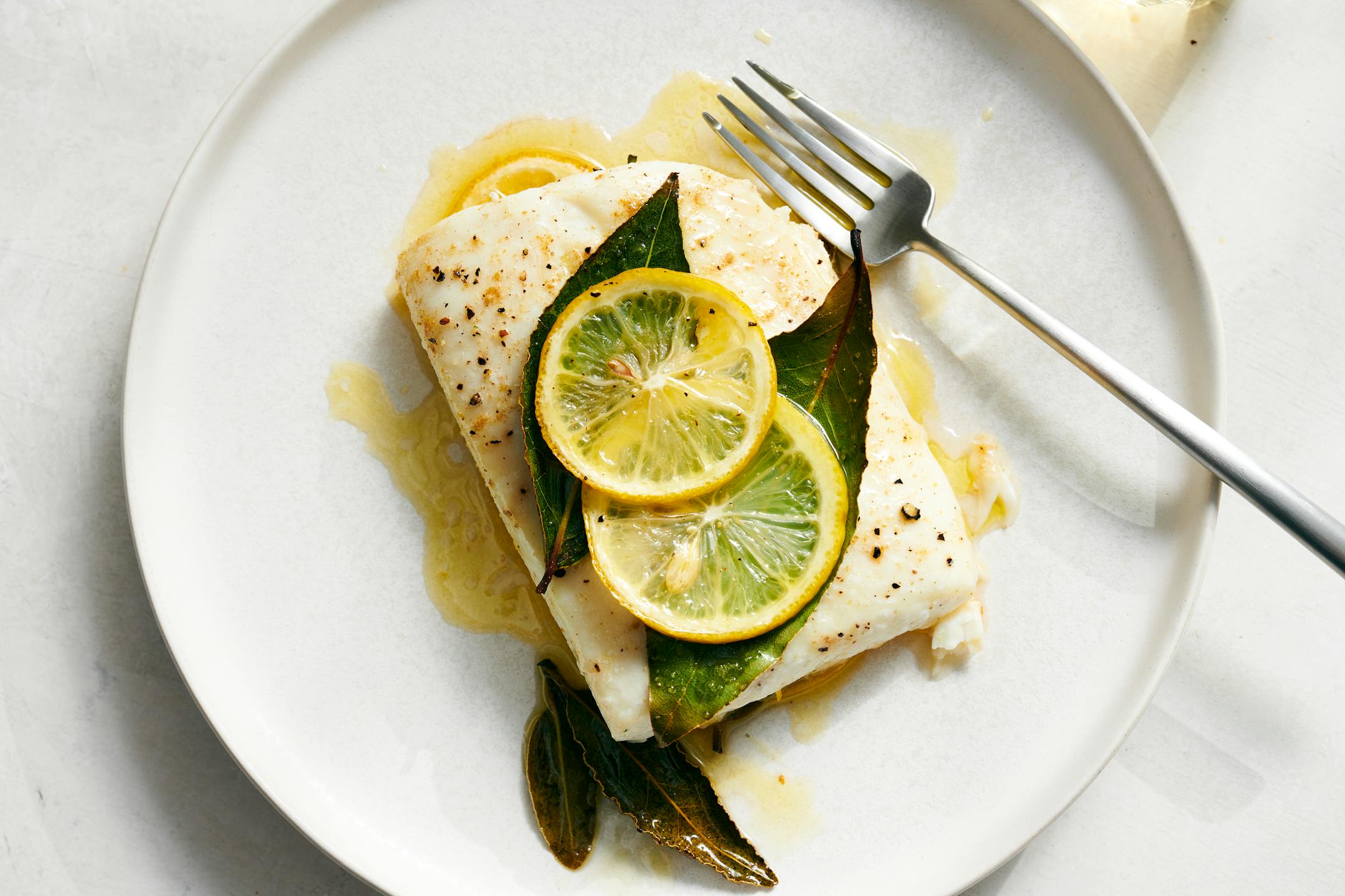 Roasted fish with cumin, lemon and bay. You can use any firm-fleshed white fish fillets in this recipe. Food styled by Simon Andrews. (David Malosh/The New York Times)