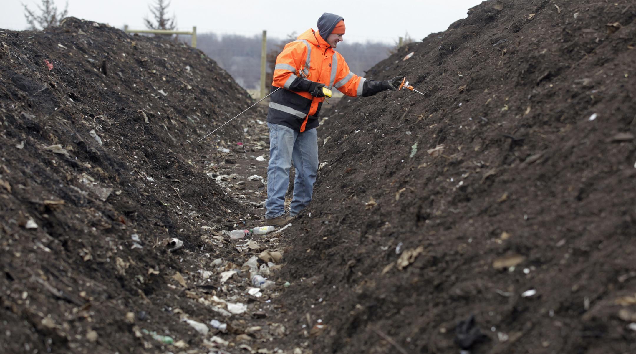 John Volkers checks the temperature of the windrow, one of the steps in the composting process Monday at the Organics Recycling Facility in Prior Lake, MN. The ideal temperature is between 140-160 degrees fahrenheit. ] (Jerry Holt/ STAR TRIBUNE/jgholt@startribune.com)