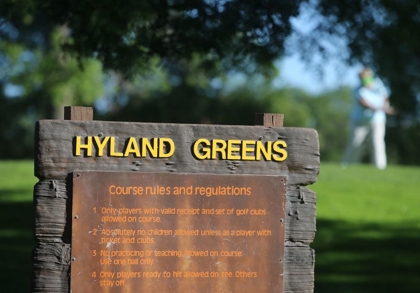 In the background a women's golf league player tees off Wednesday, July 28, 2015, at Hyland Greens golf course in Bloomington, MN.