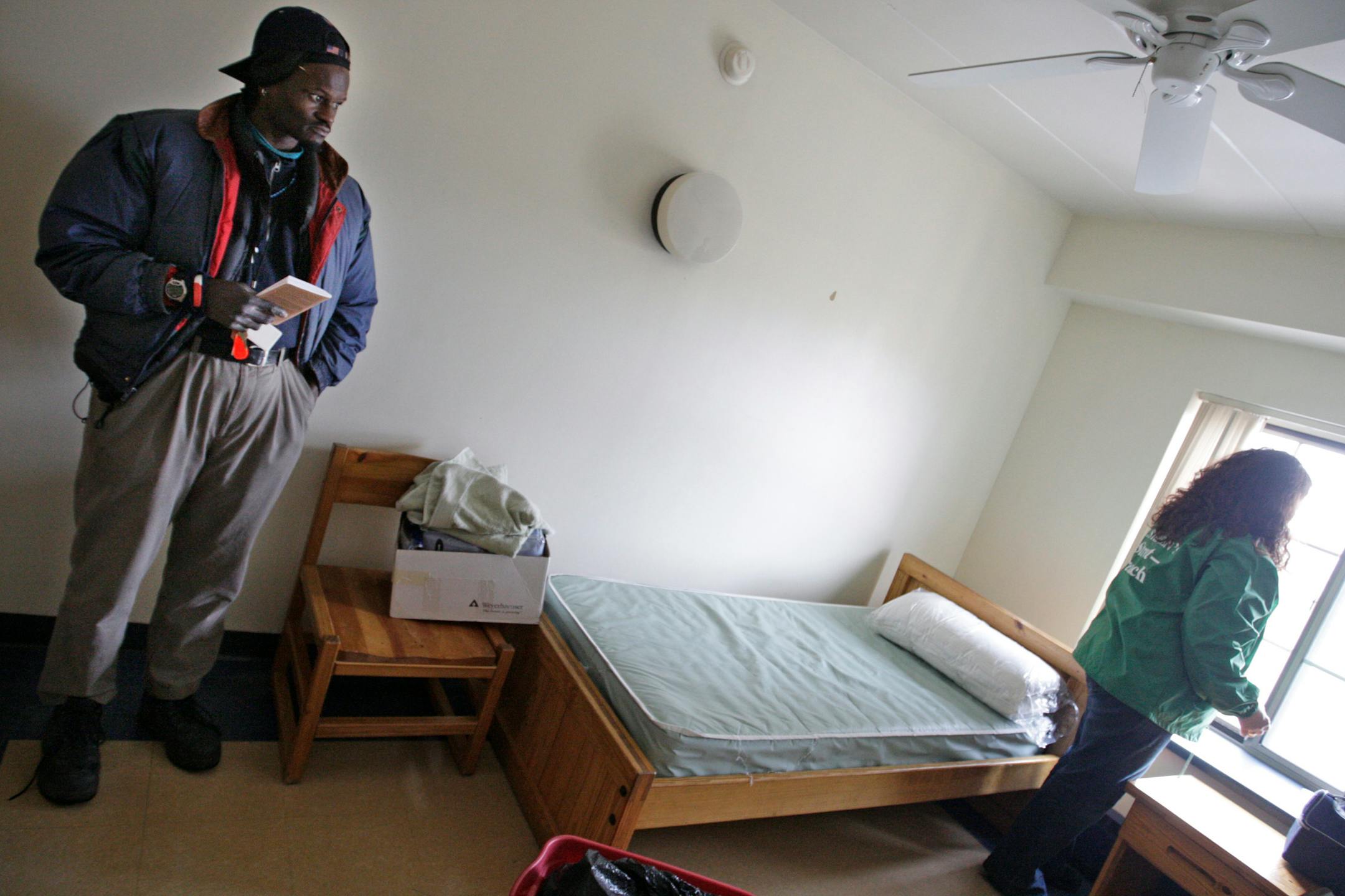 Darrell Walton, who has had a history of schizophrenia, just moved into his apartment at Evergreen Residence for the homeless. Walton now makes sure he takes his medication. St. Stephen's Human Services director Monica Nilsson helped him get situated.