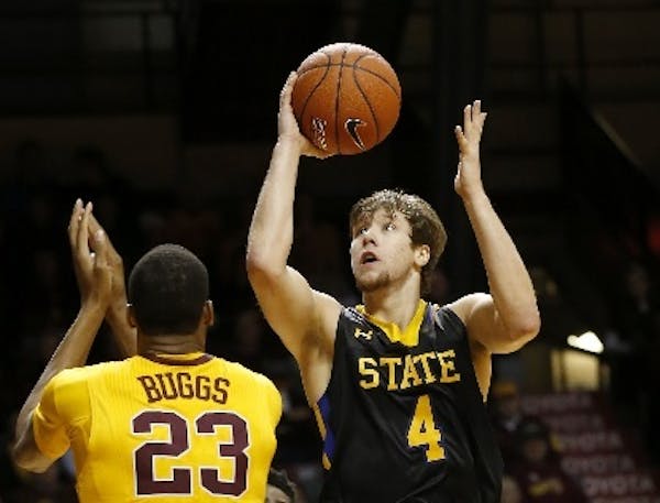 South Dakota State guard Jake Bittle shot over Gophers forward Charles Buggs during the first half of the Jackrabbits' 84-70 victory at Williams Arena