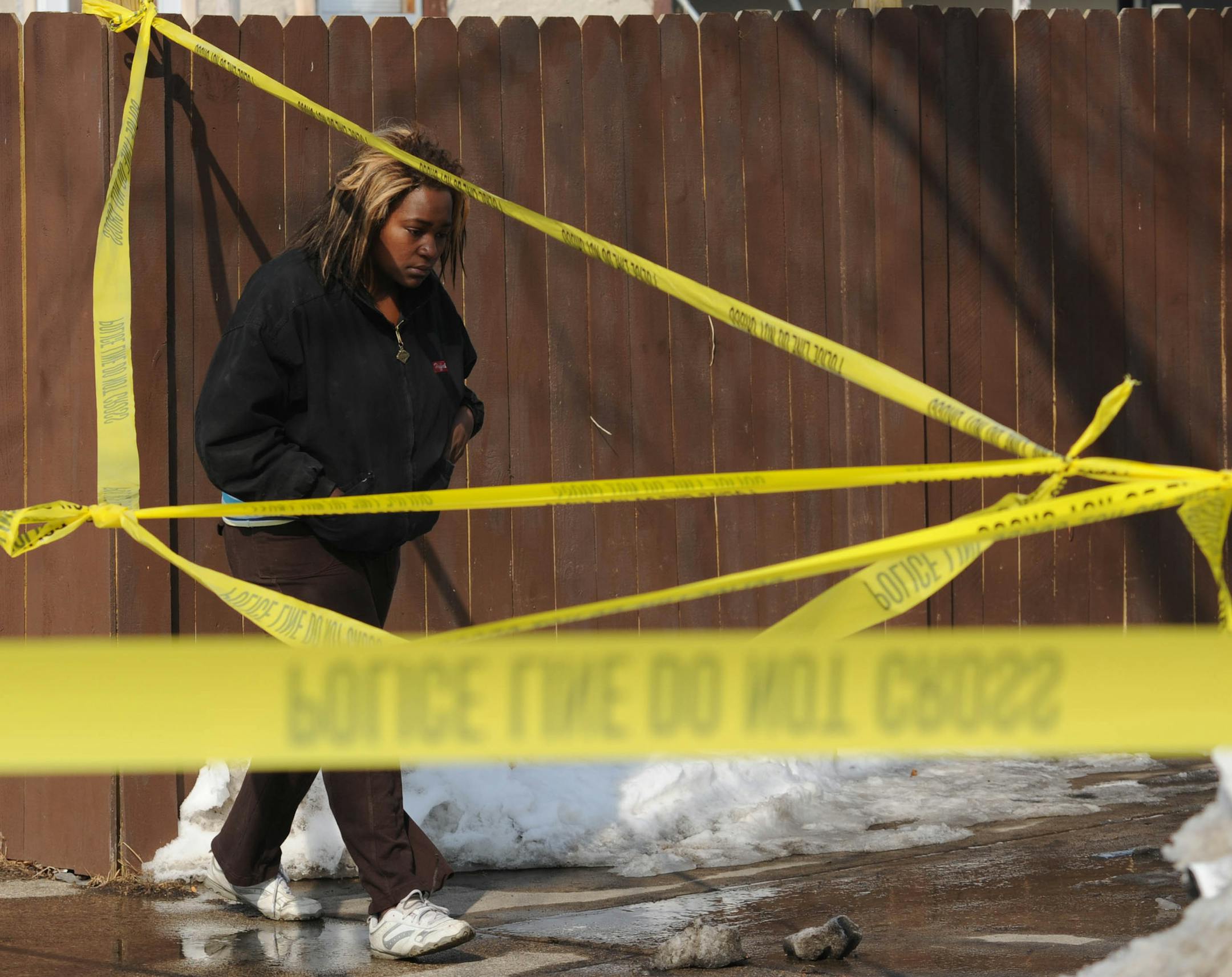 Shooting scene where Two people were fatally shot and another was wounded early Friday at an after-hours establishment at 39th St. and Fremont Av. N. in Minneapolis, according to Minneapolis police. The sister of one of the shooting victims turns away from the shooting scene in tears.] Richard.Sennott@startribune.com Richard Sennott/Star Tribune. , Minneapolis Minn.Friday 3/8/13) ** she would not give me her name (cq)