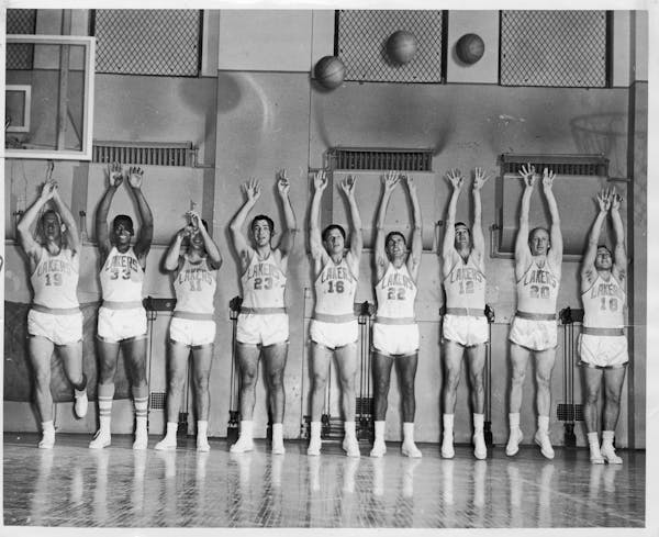 Members of the 1956-57 Minneapolis Lakers, from left, Vern Mikkelsen, Bob Williams, Jim Paxton, Ed Kalafat, Dick Garmaker, Al Bianchi, Bob Leonard, Wh