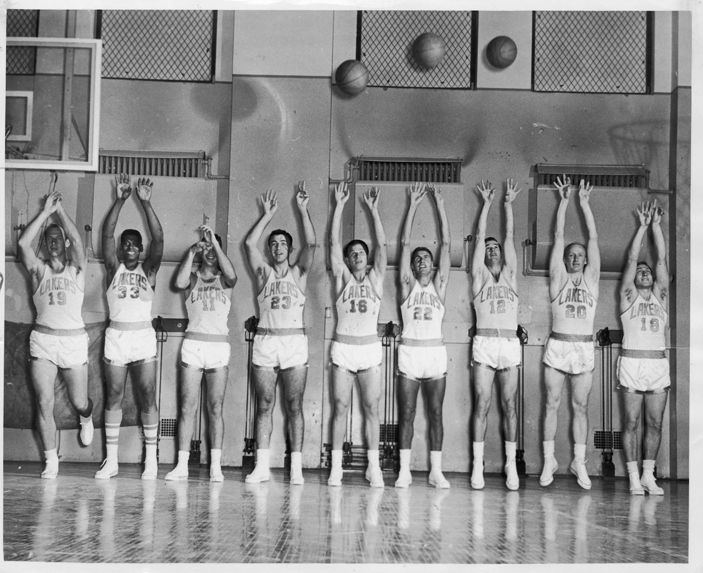 Members of the 1956-57 Minneapolis Lakers, from left, Vern Mikkelsen, Bob Williams, Jim Paxton, Ed Kalafat, Dick Garmaker, Al Bianchi, Bob Leonard, Whitey Skoog and Charley Mencel.