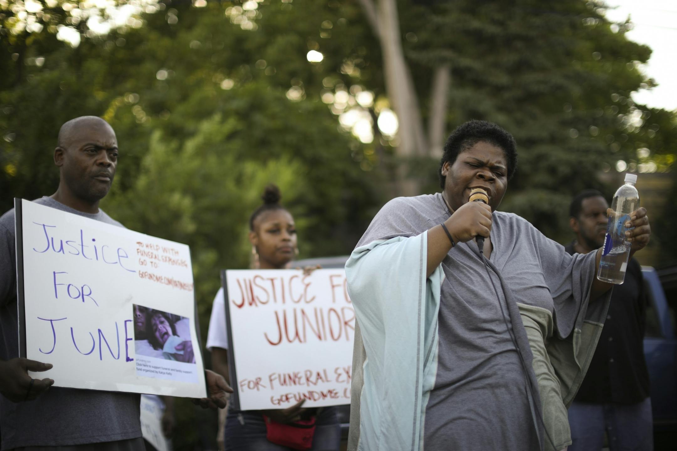 Thurman Blevins' sister, Darlynn Blevins, spoke about her brother to the crowd, gathered in the parking lot of Cub Foods, before they left on the Peace Walk. At left is Thurman's brother, Joseph Blevins.