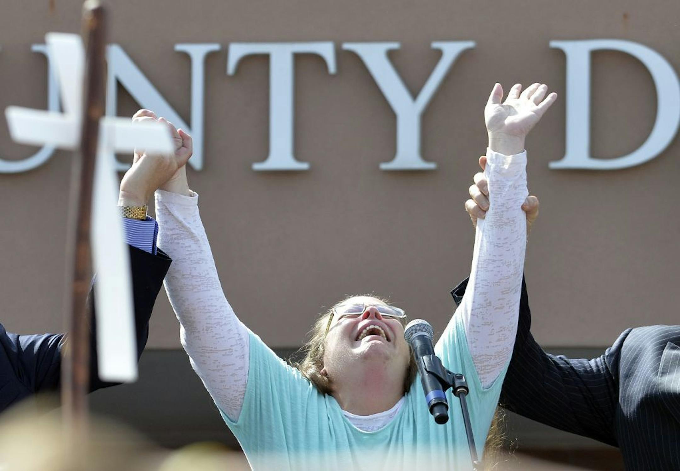 Rowan County Clerk Kim Davis cries out after being released from the Carter County Detention Center, Tuesday, Sept. 8, 2015, in Grayson, Ky. Davis, the Kentucky county clerk who was jailed for refusing to issue marriage licenses to gay couples, was released Tuesday after five days behind bars.