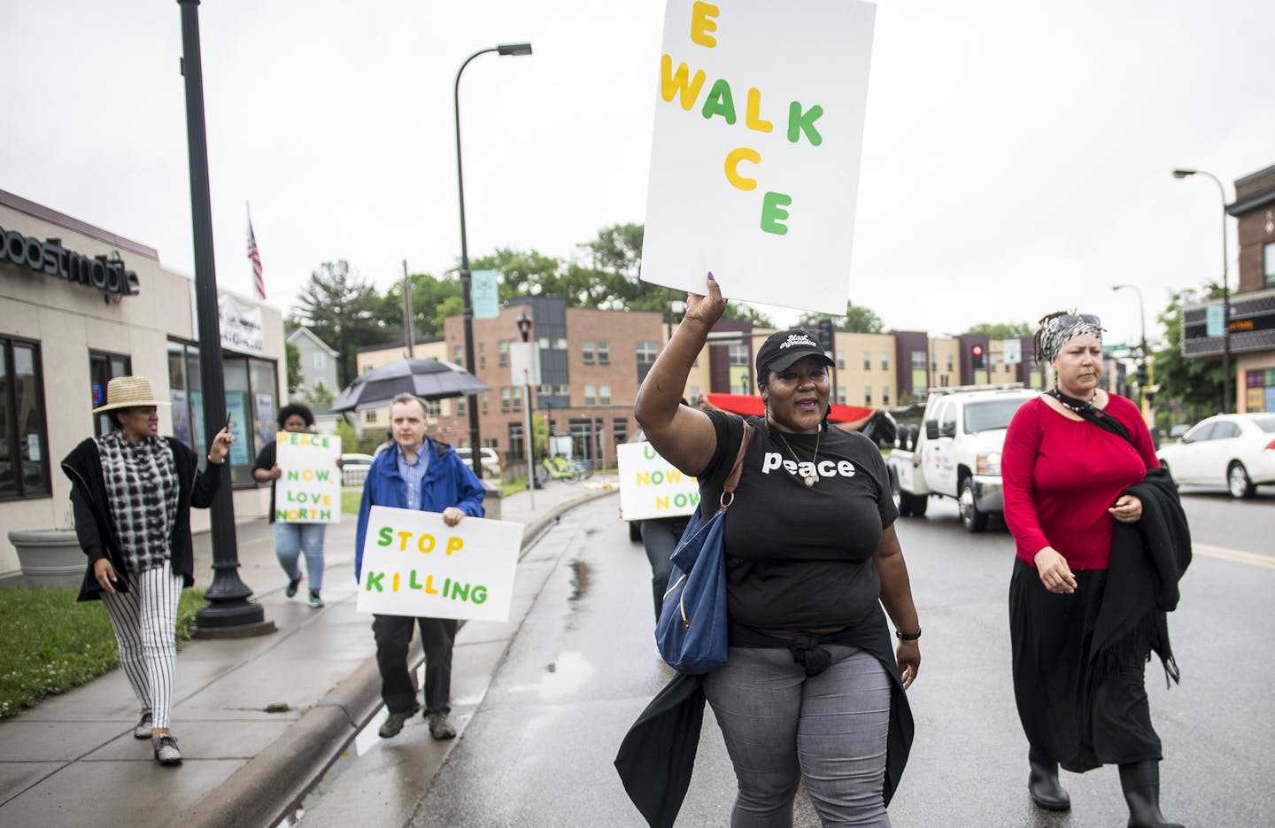 Community members were led along West Broadway Avenue during a peace walk in north Minneapolis by community activist, Shantae Peace, Friday afternoon. ] (AARON LAVINSKY/STAR TRIBUNE) aaron.lavinsky@startribune.com Next day followup on the fatal shooting of Birdell Beatrice Beeks, a 59-year-old woman killed in a fatal shooting Thursday night.