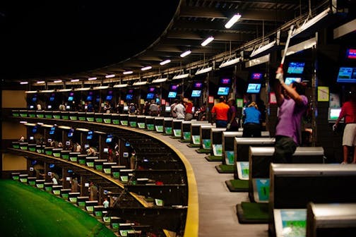 The interior of a Topgolf center.