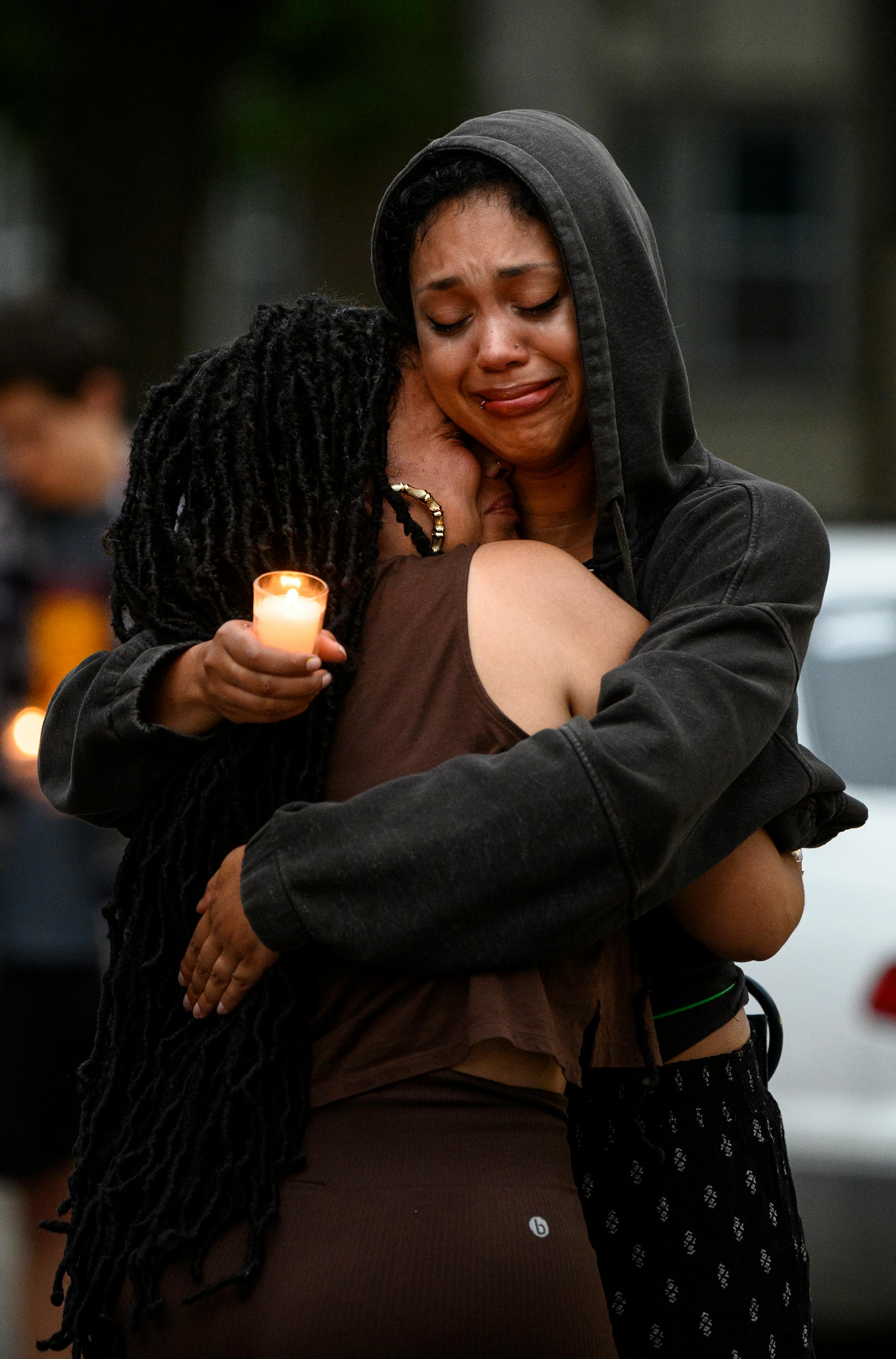 Two mourners embraced during a vigil Thursday for 20-year old Andrew Tekle Sundberg.