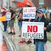Dozens of protesters stood in the rain Tuesday morning outside St. Louis County&#x2019;s government services building in Virgnia, Minn.