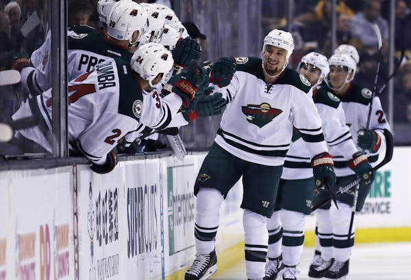 Minnesota Wild right wing Chris Stewart, center, is congratulated by teammates after his goal against Boston Bruins goalie Malcolm Subban during the s