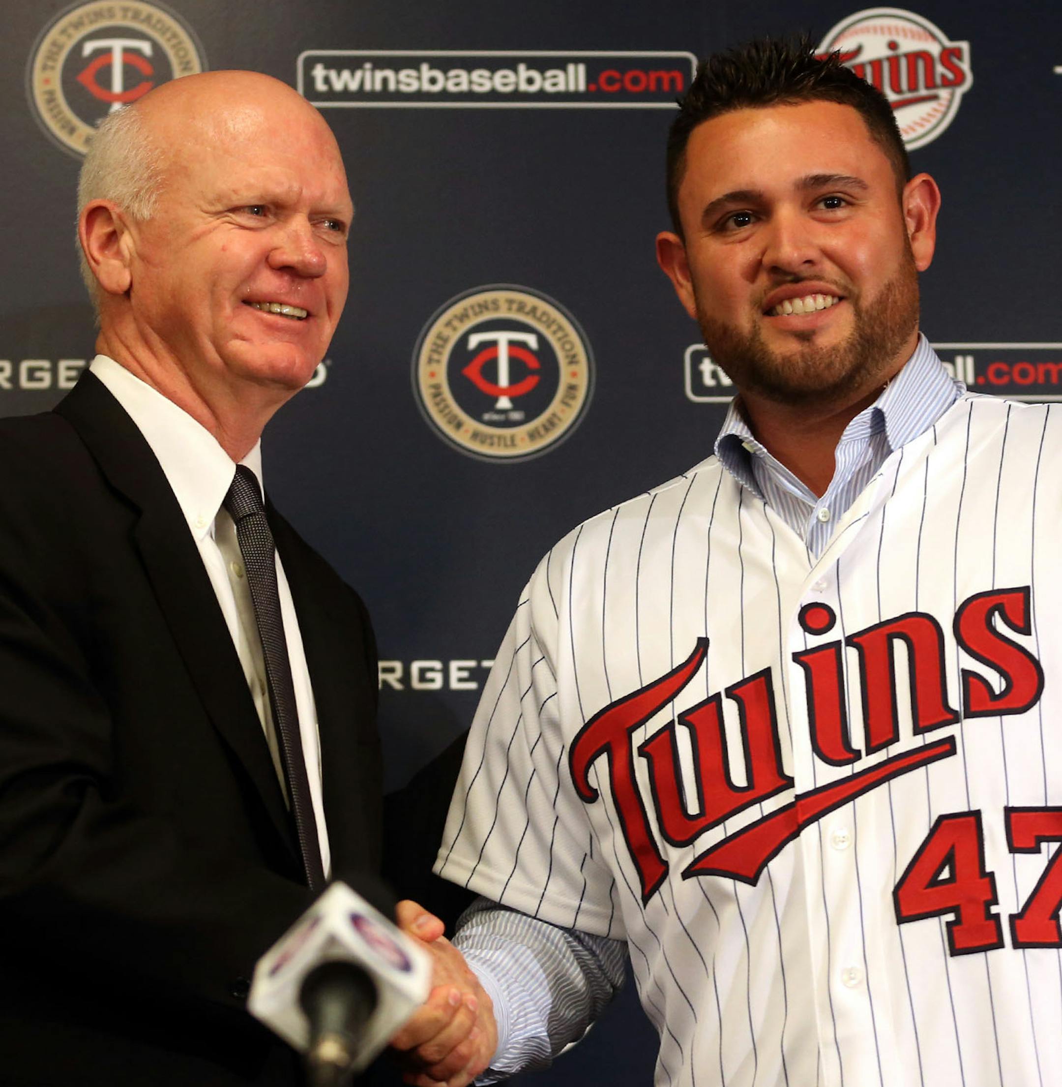 Twins general manager Terry Ryan shook hands with free-agent signee Ricky Nolasco with his new jersey on during a press conference at Target Field in Minneapolis, Tuesday, December 3, 2013. ] (KYNDELL HARKNESS/STAR TRIBUNE) kyndell.harkness@startribune.com