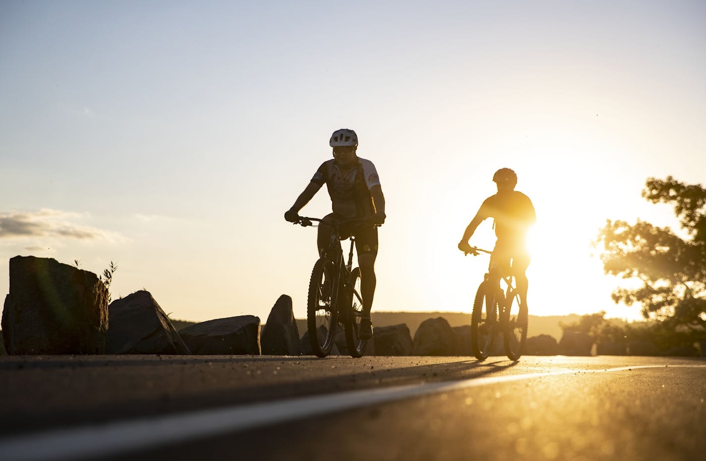 Two bikers rode along skyline parkway in Duluth, MN on Thursday during sunset.