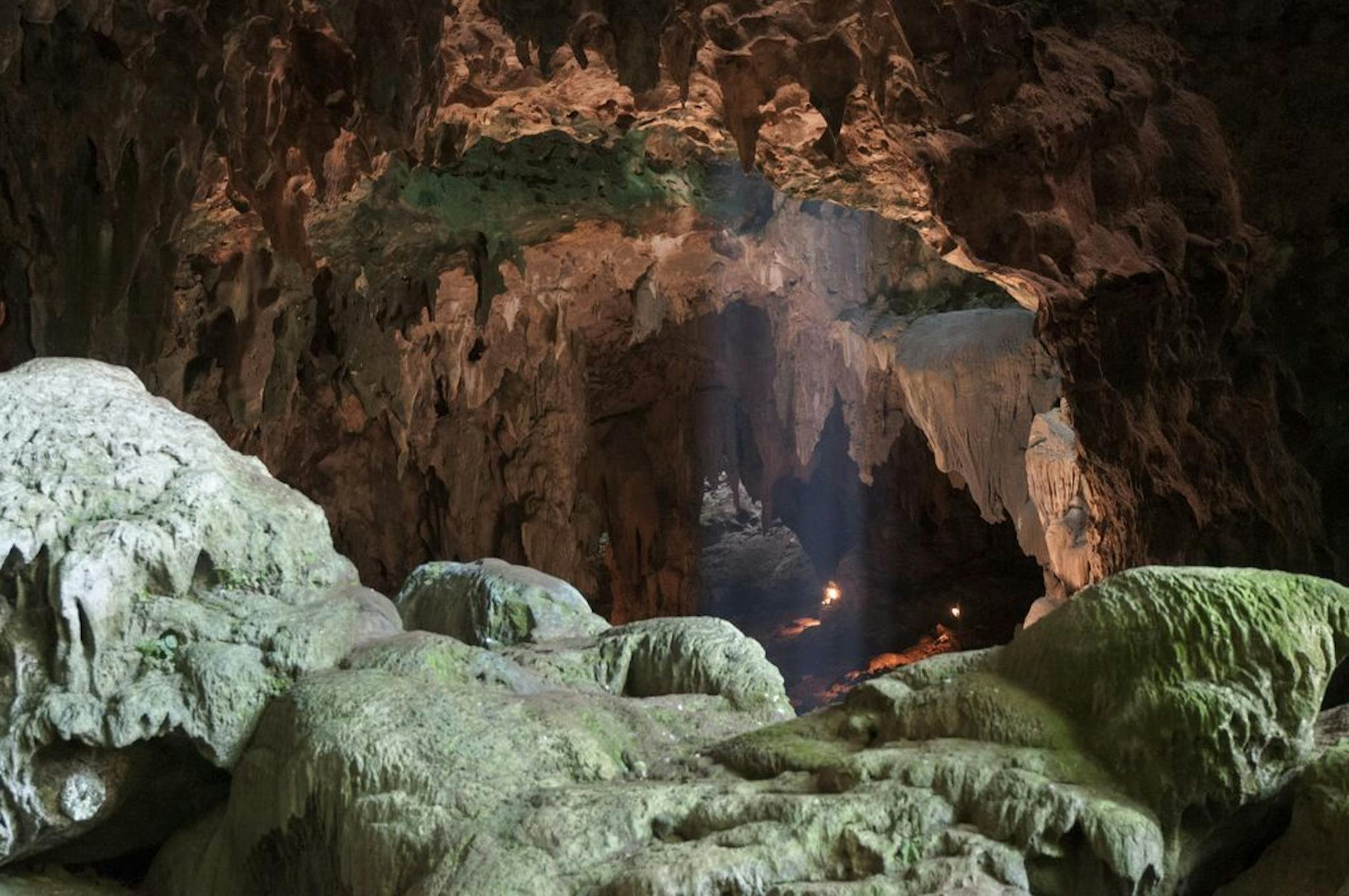 This undated photo provided by the Callao Cave Archaeology Project in April 2019 shows Callao Cave on Luzon Island of the Philippines, where the fossils of Homo luzonensis were discovered. This view is taken from the rear of the first chamber of the cave, where the fossils were found, in the direction of the second chamber. In a study released on Thursday, April 10, 2019, scientists report that tests on two samples from the species show minimum ages of 50,000 years and 67,000 years.