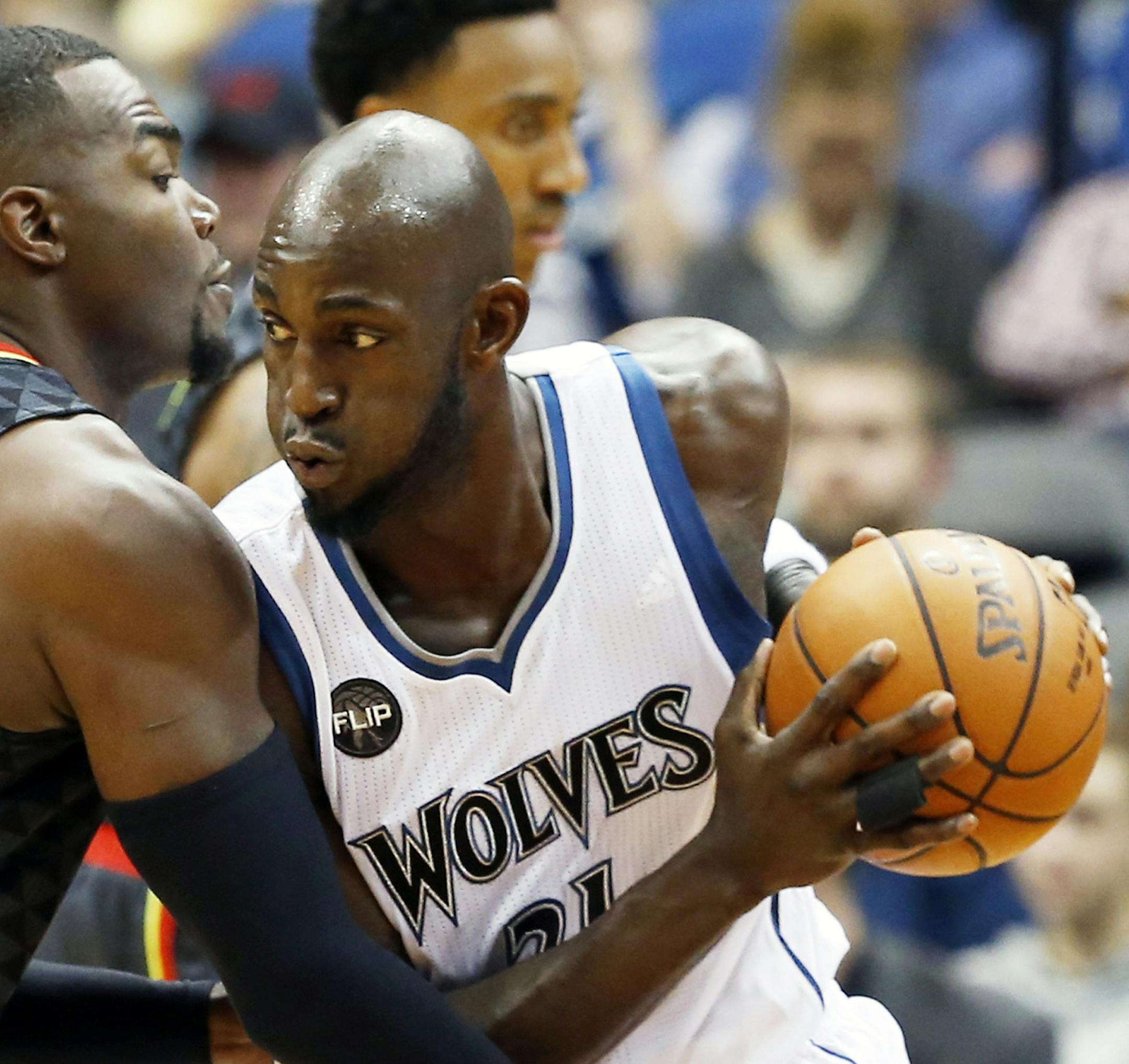 FILE - In this Nov. 25, 2015, file photo, Minnesota Timberwolves' Kevin Garnett, right, drives on Atlanta Hawks' Paul Millsap in the first quarter of an NBA basketball game in Minneapolis. A person with knowledge of the decision tells The Associated Press that Garnett has informed the Timberwolves that he will retire after 21 seasons. The two sides came to agreement on a buyout on Friday, Sept. 23 2016, the person said. (AP Photo/Jim Mone, File)