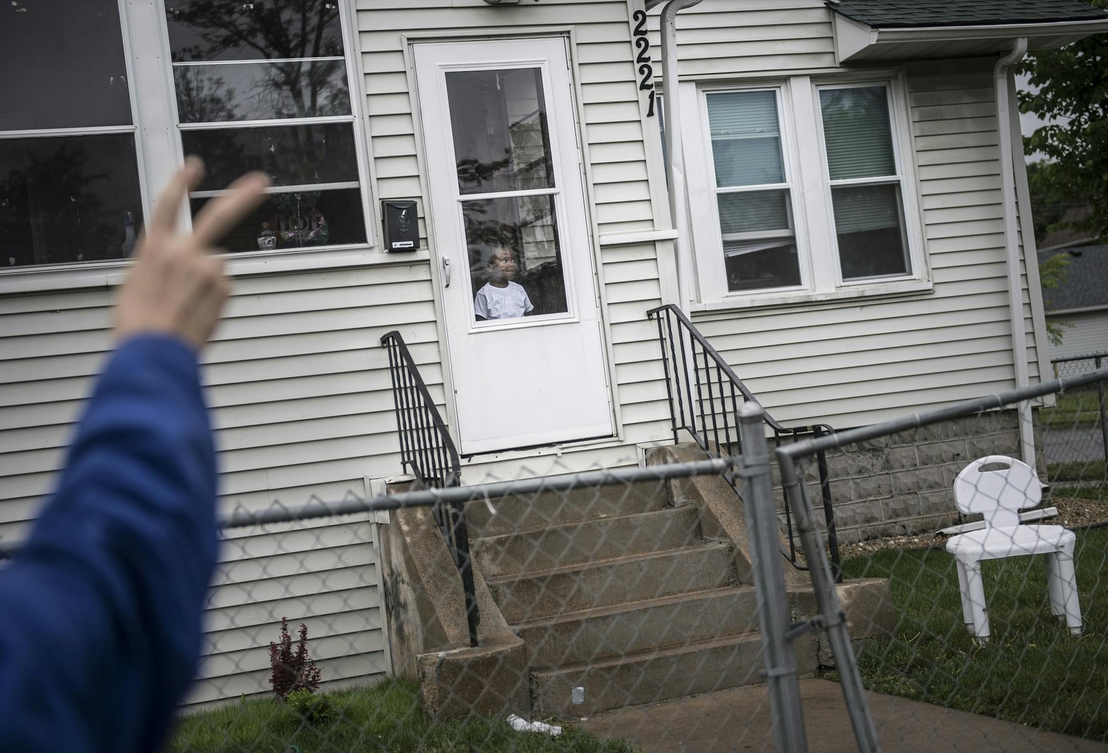 Minneapolis City Councilman Cam Gordon flashed a peace sign to a young child watching a peace march in north Minneapolis along Penn Avenue Friday afternoon.