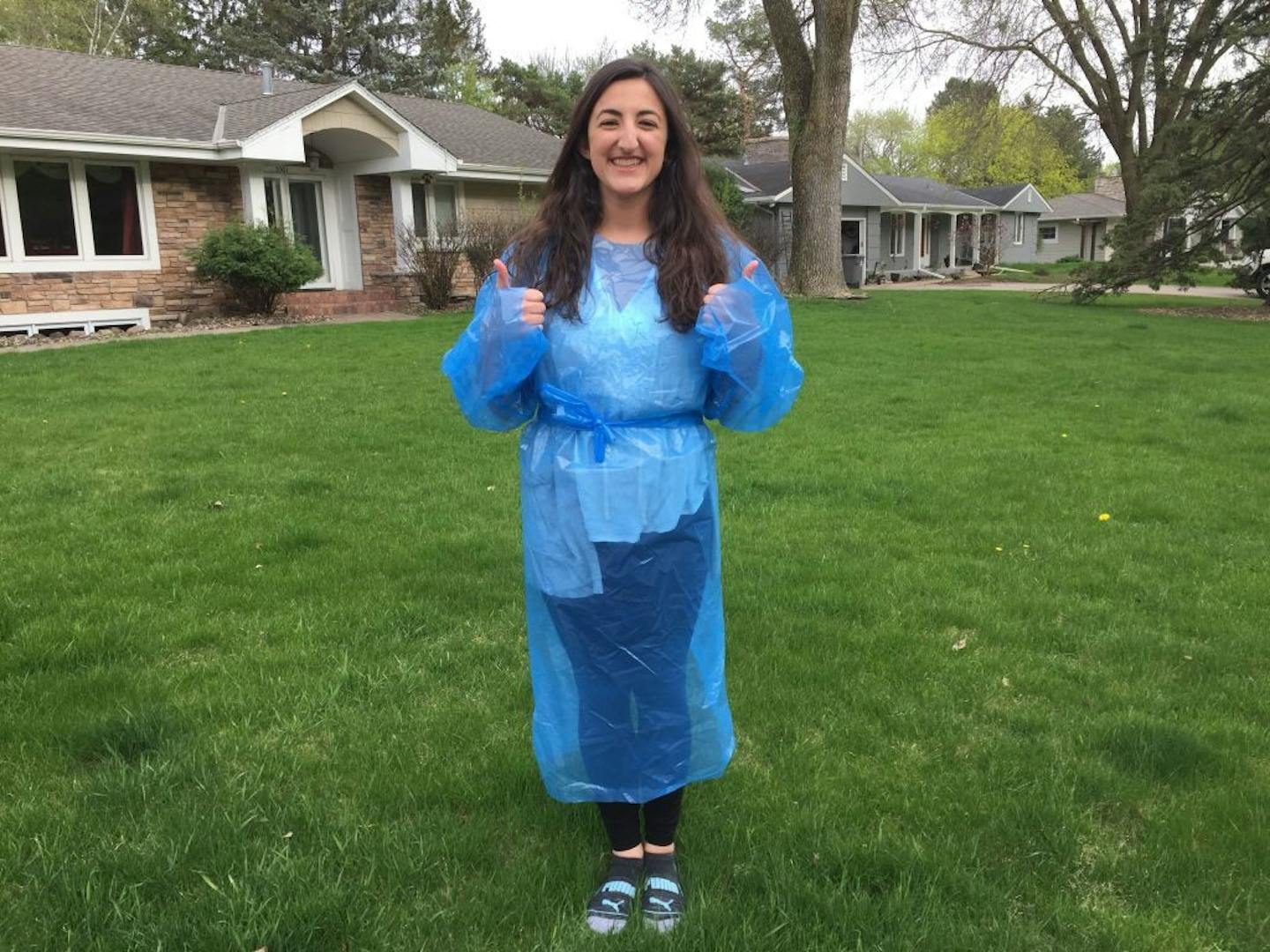 University of Minnesota student Anna Karos models one of the protective gowns she helped design. Students managed to get the gowns designed, approved by the FDA, and into production locally in the space of two weeks. Photo credit: Professor Steven Saliterman