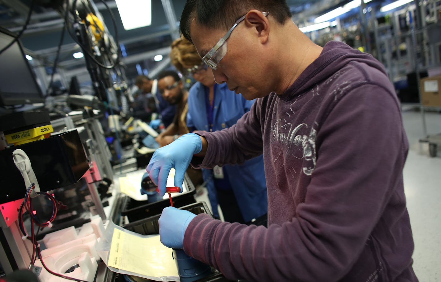 Huoi Thai tested one of the custom made wired pressure gauges produced in Chanhassen. ] (KYNDELL HARKNESS/STAR TRIBUNE) kyndell.harkness@startribune.com Emerson Process Management in Chanhassen Min., Wednesday, October 15, 2014.