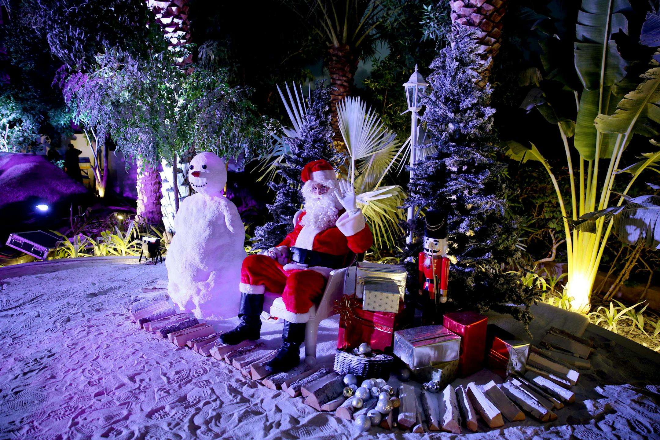 FILE - In this Friday, Dec. 20, 2013 file photo, a man dressed as Santa Claus waits for guests to join him for a photograph during a Christmas party in Dubai, United Arab Emirates. Britain wants to make sure its citizens are more nice than naughty while soaking up the Persian Gulf sun this holiday season. A social media campaign by British Embassy staff in the United Arab Emirates running in December, 2014 is a play on the classic poem "'Twas the Night Before Christmas," and includes travel advi