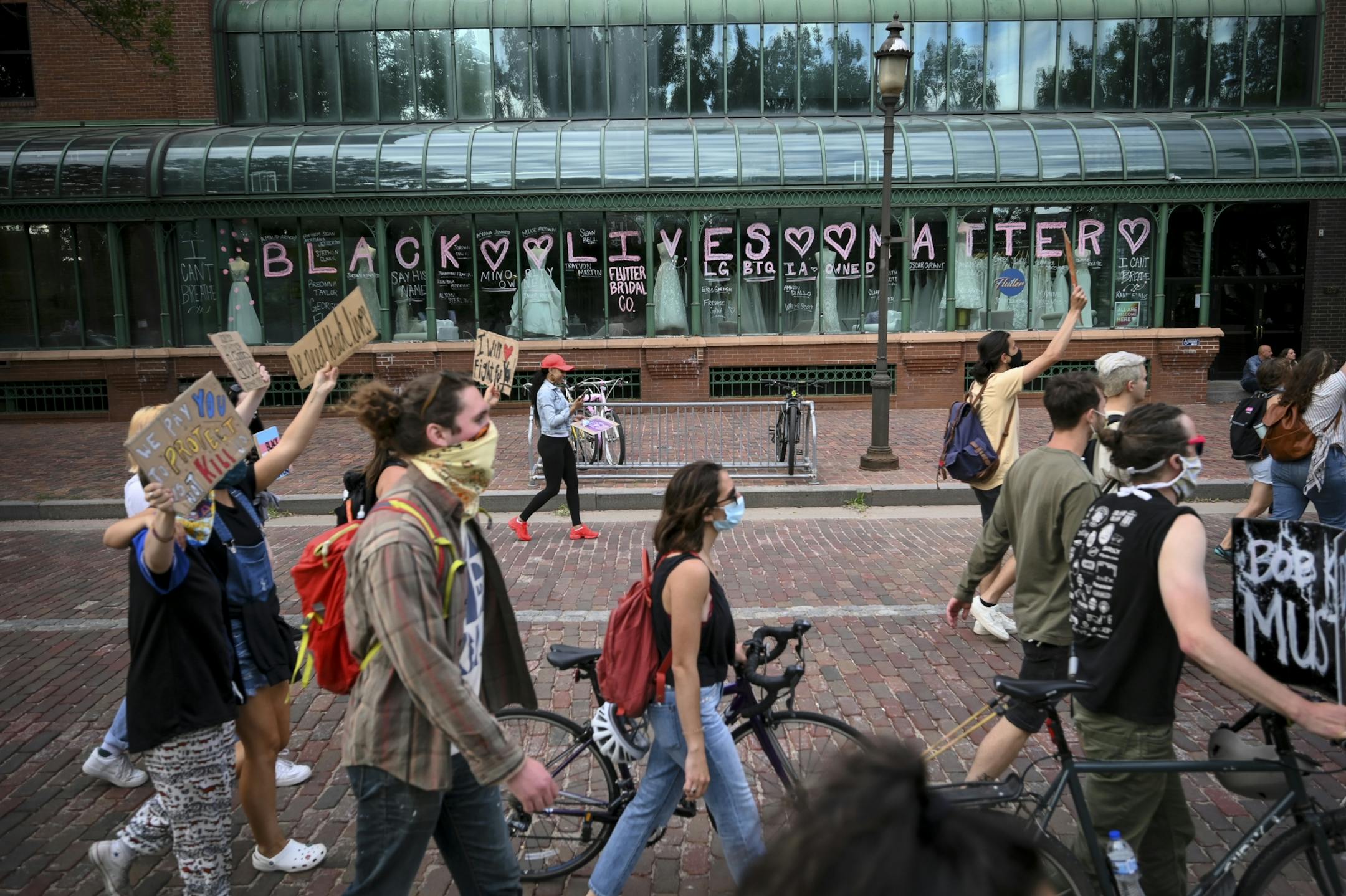 Protesters passed the Flutter Bridal Company in Minneapolis Saturday.