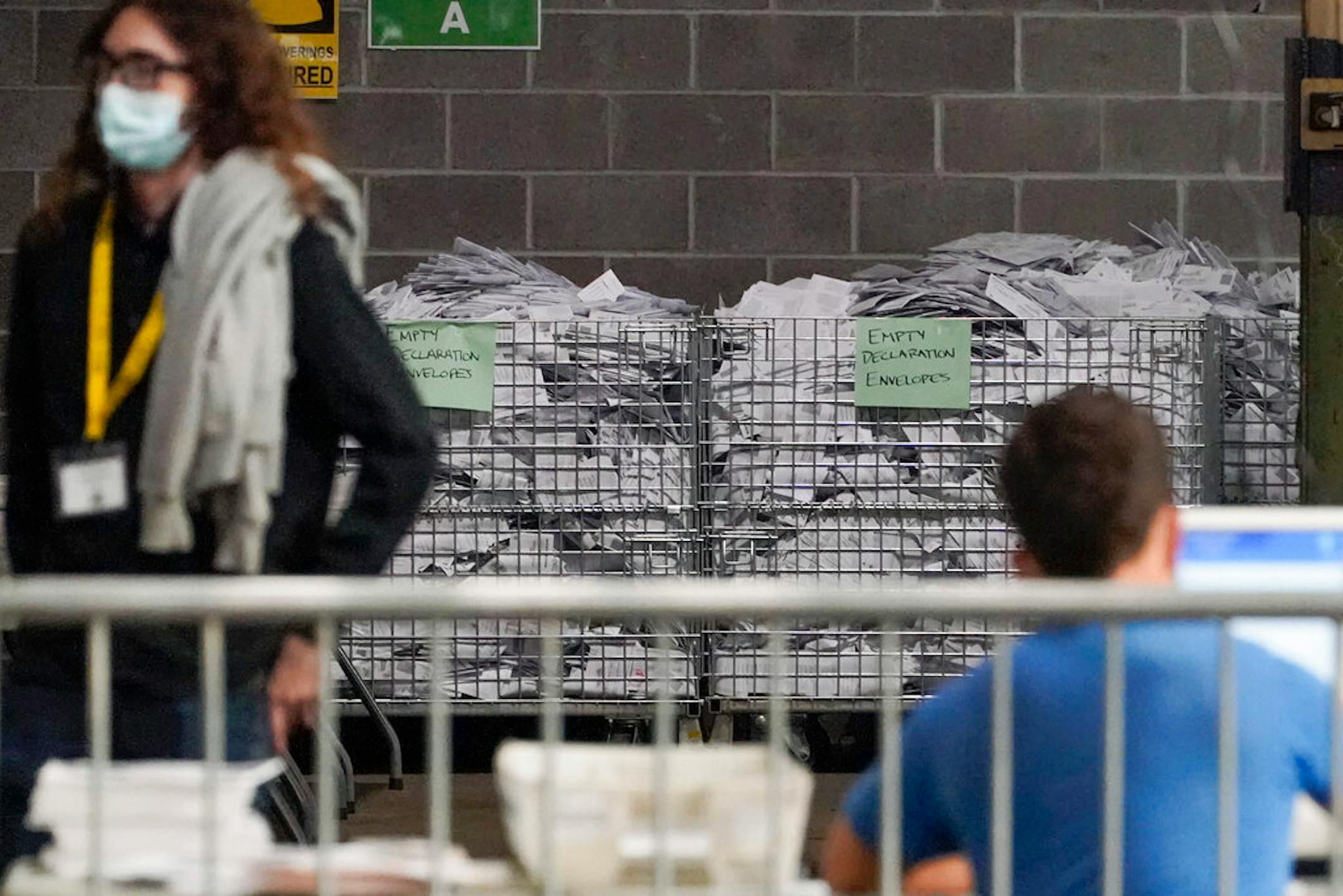 Bins of the empty envelopes from ballots are stored along a wall as election office workers process ballots while counting continues from the general election at the Allegheny County elections returns warehouse in Pittsburgh, Friday, Nov. 6, 2020. (AP Photo/Gene J. Puskar)