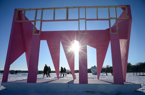 A group of lake walkers makes their way past "Introspective Monument," by the Temple of Agency, Tuesday, Jan. 11, 2022 on Lake Harriet in Minneapolis, Minn. After a yearlong pandemic break, Art Shanty starts again this Saturday, and runs on weekends until Feb. 6.       ] AARON LAVINSKY • aaron.lavinsky@startribune.com