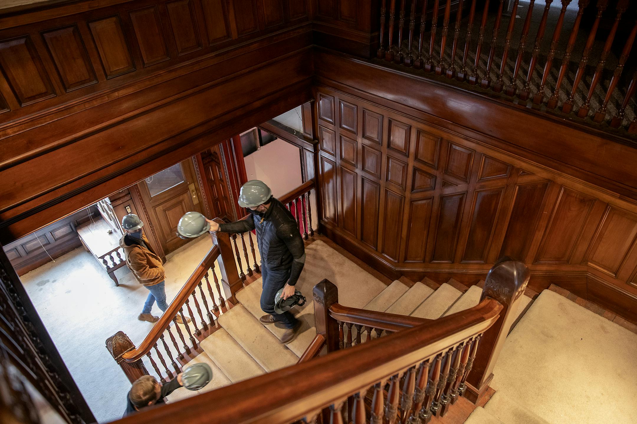 Brian Woolsey made his way down a stairwell as he handed out construction helmets as they worked on the old mansion, Thursday, October 29, 2020 in Minneapolis, MN. The historic mansion near Loring Park is being converted into a new 127-unit rental apartment building. ] ELIZABETH FLORES • liz.flores@startribune.com