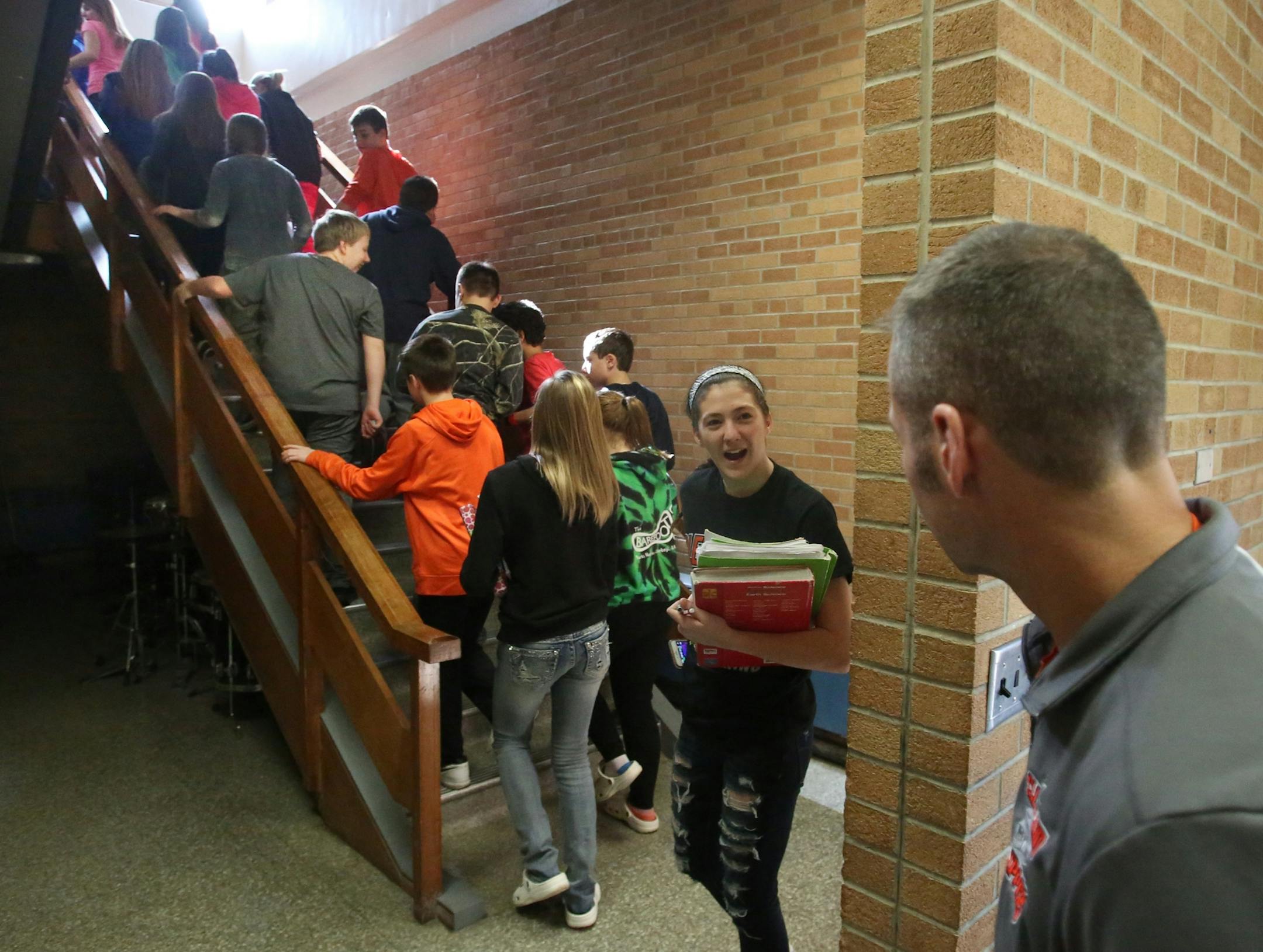 Erik Hermanson, band teacher and football coach at Cleveland Public School, chats with 7th and 8th graders headed to their next class after band practice Tuesday, Feb. 21, 2017, in Cleveland, MN. Almost 90 percent of school students participate in band, where the space can not accommodate all the students.