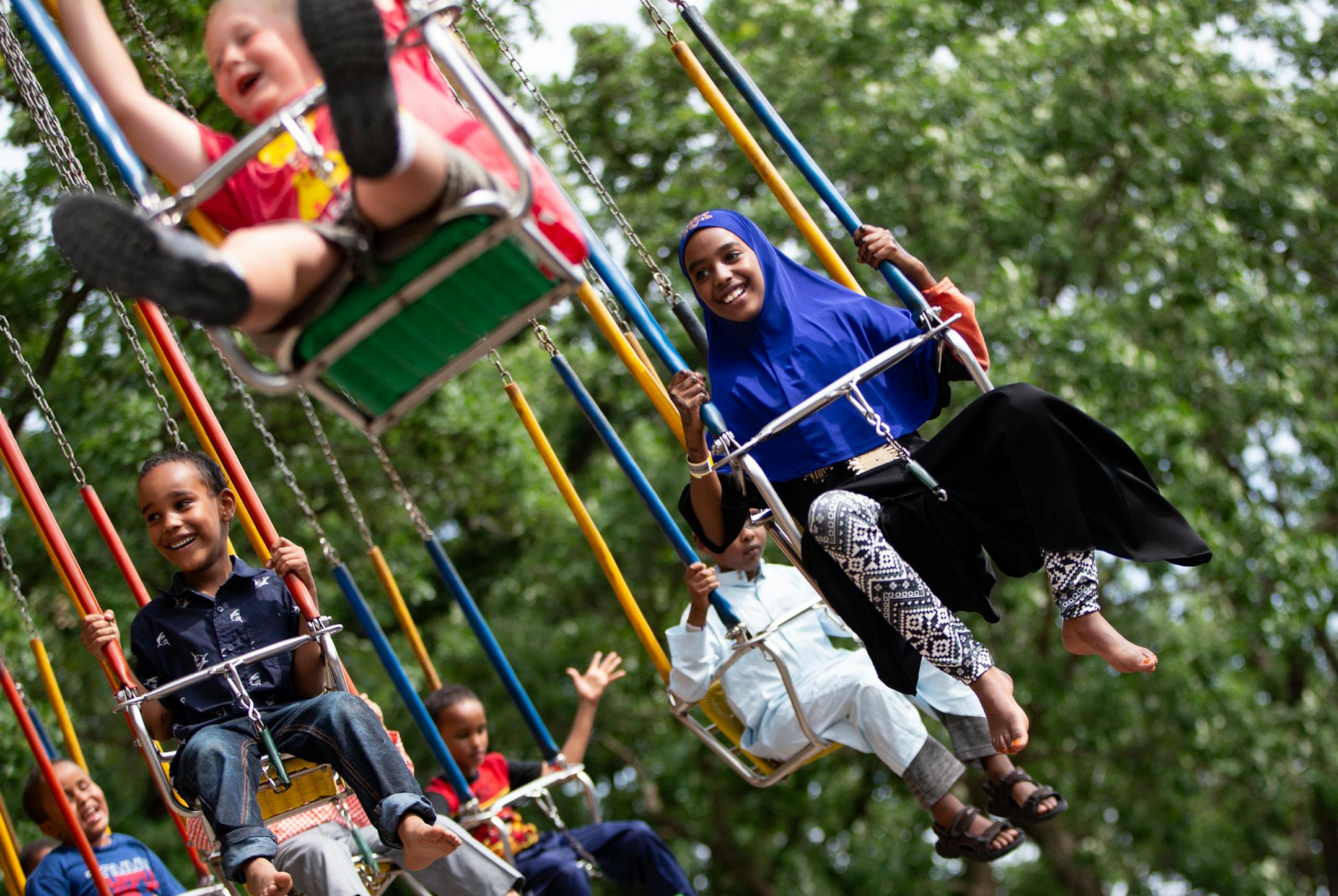 Yusra Bashir enjoys the giant swing ride at Como Town on the first day of Eid on Friday. ] ALEX KORMANN • alex.kormann@startribune.com Friday, June 15, 2018 is the first day of Eid, the Islamic holiday celebrating the end of Ramadan. After thirty days of fasting, families celebrate by going to their Mosque for prayer in the morning and then spending the day together having fun. Como Park is a popular spot for families with young kids to enjoy the day. There they enjoy the rides, food and