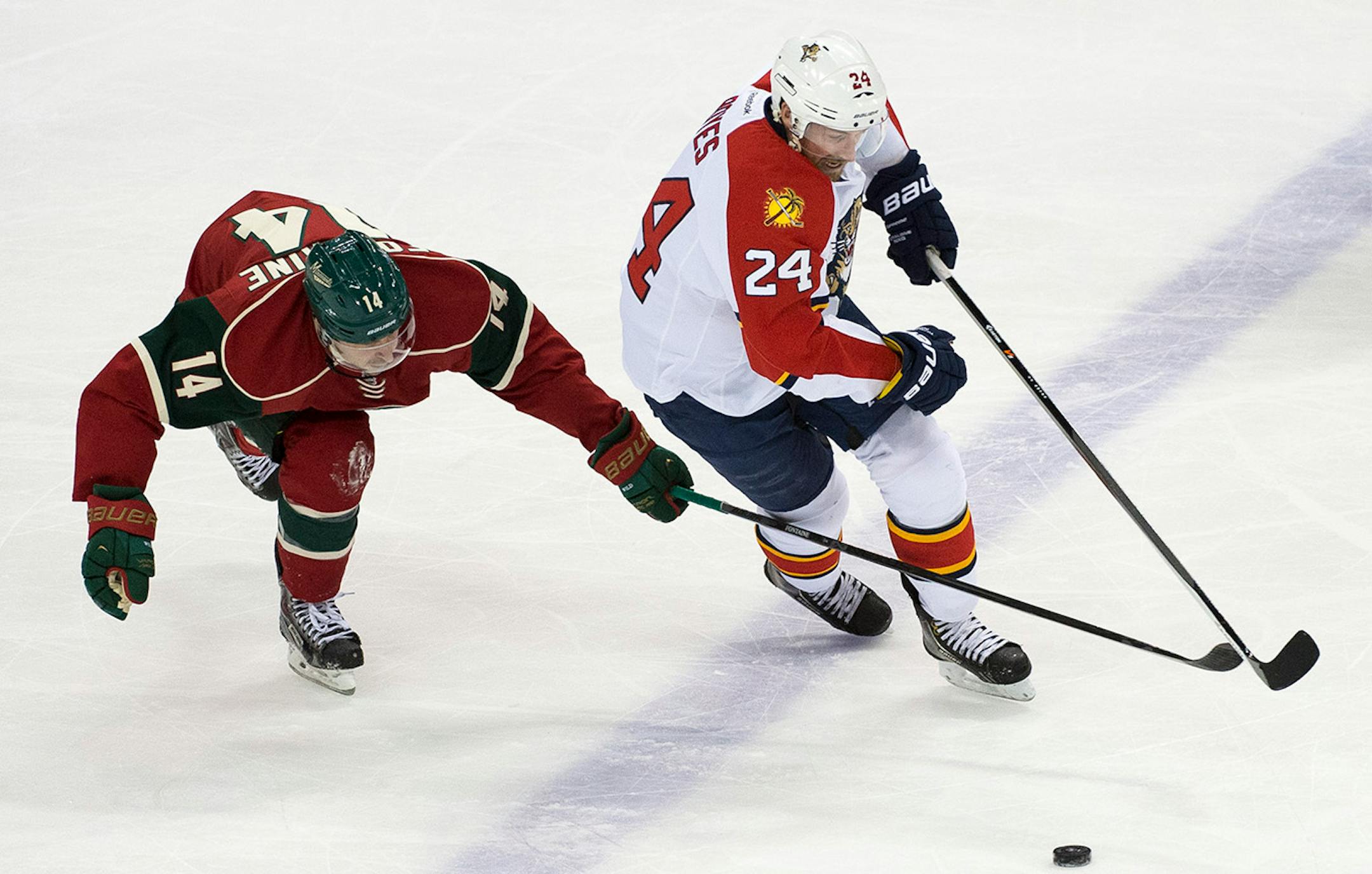 Minnesota Wild right wing Justin Fontaine (14) and Florida Panthers right wing Brad Boyes (24) chase down the puck during the third period. ] (Aaron Lavinsky | StarTribune) The Minnesota Wild take on the Florida Panthers Thursday, Feb. 12, 2015 at Xcel Energy Center in St. Paul.