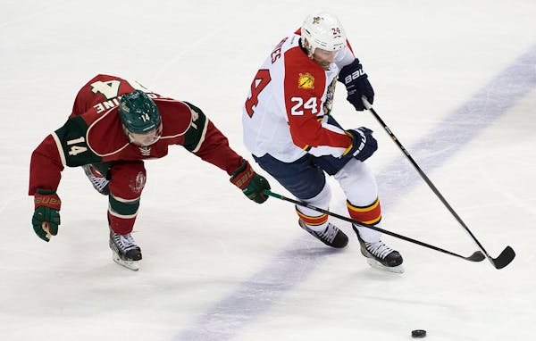 Minnesota Wild right wing Justin Fontaine (14) and Florida Panthers right wing Brad Boyes (24) chase down the puck during the third period. ] (Aaron L
