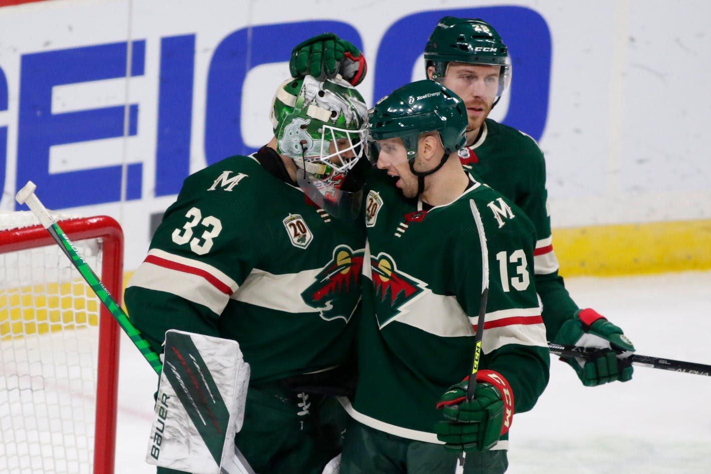 Minnesota Wild goalie Cam Talbot (33) is congratulated by center Nick Bonino (13) after defeating the Los Angeles Kings in an NHL hockey game, Friday, Feb. 26, 2021, in St. Paul, Minn. (AP Photo/Andy Clayton-King)