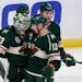 Minnesota Wild goalie Cam Talbot (33) is congratulated by center Nick Bonino (13) after defeating the Los Angeles Kings in an NHL hockey game, Friday,