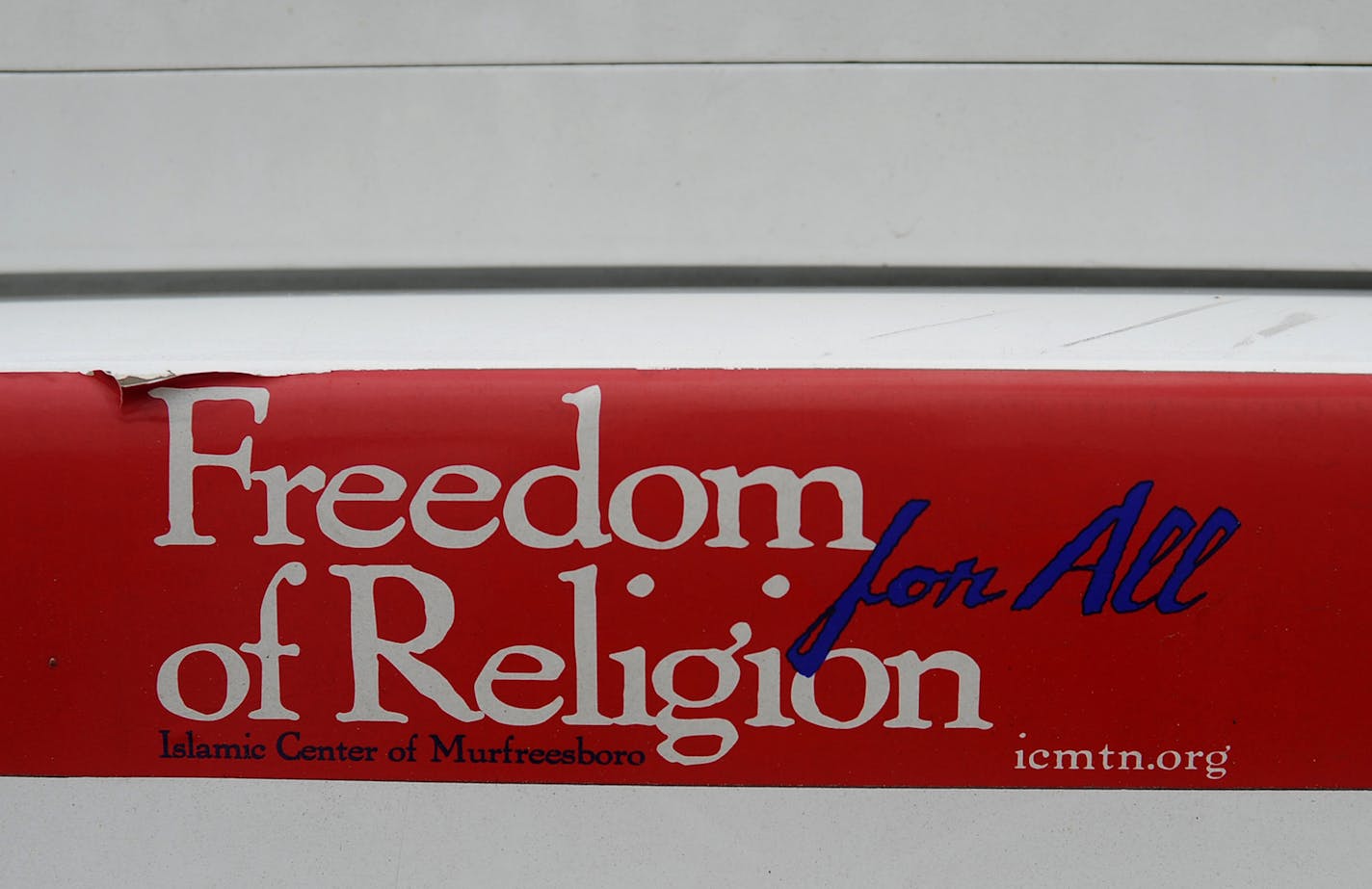 A "Freedom of Religion for All" bumper sticker is displayed on the rear bumper of the car that belongs to the Islamic Center of Murfreesboro Imam Ossama Bahloul while parked outside the mosque before afternoon prayers on the first day of the Islamic holy month of Ramadan Friday, July 20, 2012 in Murfreesboro, Tenn. A new mosque is nearing completion after a court battle with opposition groups. (AP Photo/Stephen Lance Dennee) ORG XMIT: TNLD101