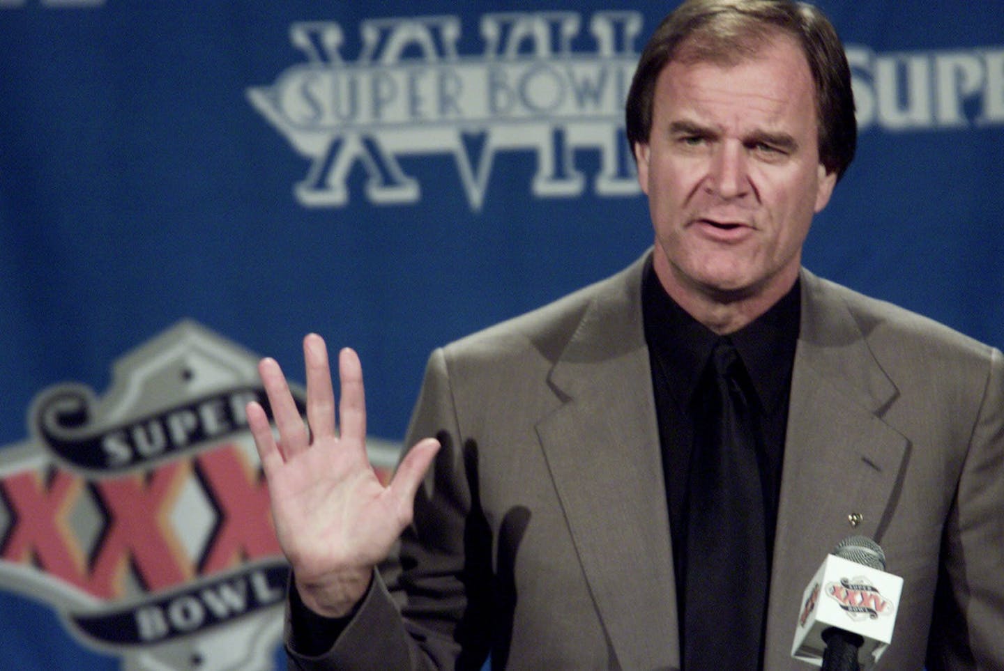 Baltimore Ravens coach Brian Billick advises reporters how the team will address with the media this week the past legal problems of Ravens linebacker Ray Lewis, who did not attend the news conference, during the team's first media session after their arrival Monday, Jan. 22, 2001 in Tampa for Super Bowl XXXV. Lewis was arrested after last year's Super Bowl in connection with the deaths of two men in Atlanta but was subsequently acquitted of murder charges. (AP Photo/Roberto Borea)