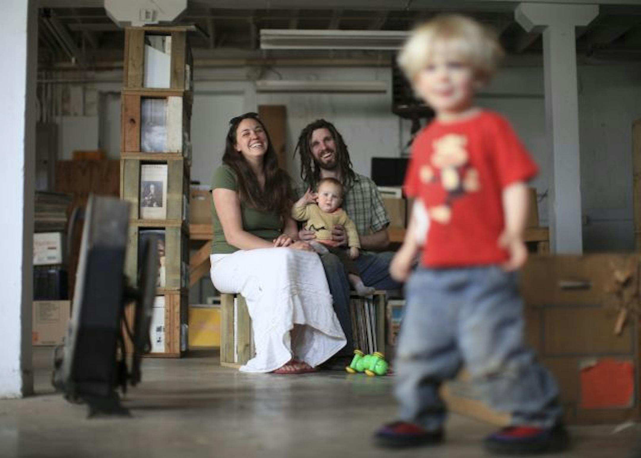 Dave and Laura Hoenack, who have owned Hymie's Records for about a year, with their kids, Nova and Gus, foreground, in the basement of their store Friday afternoon. Nearly all the stock in the basement has been moved to the new location already.