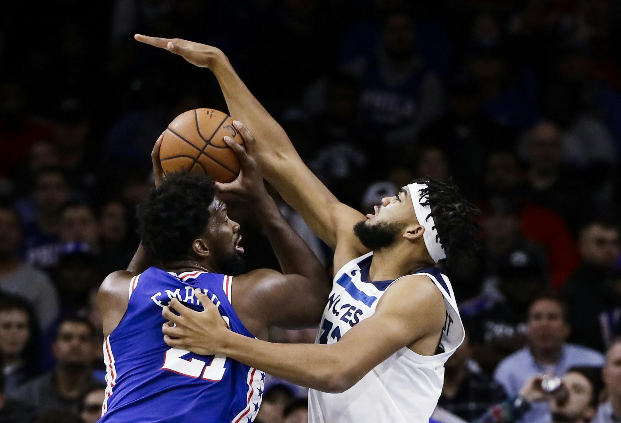 Philadelphia 76ers' Joel Embiid, left, looks for a shot as Minnesota Timberwolves' Karl-Anthony Towns defends during the first half of an NBA basketball game Wednesday, Oct. 30, 2019, in Philadelphia. The 76ers won 117-95. (AP Photo/Matt Rourke) ORG XMIT: PXC107