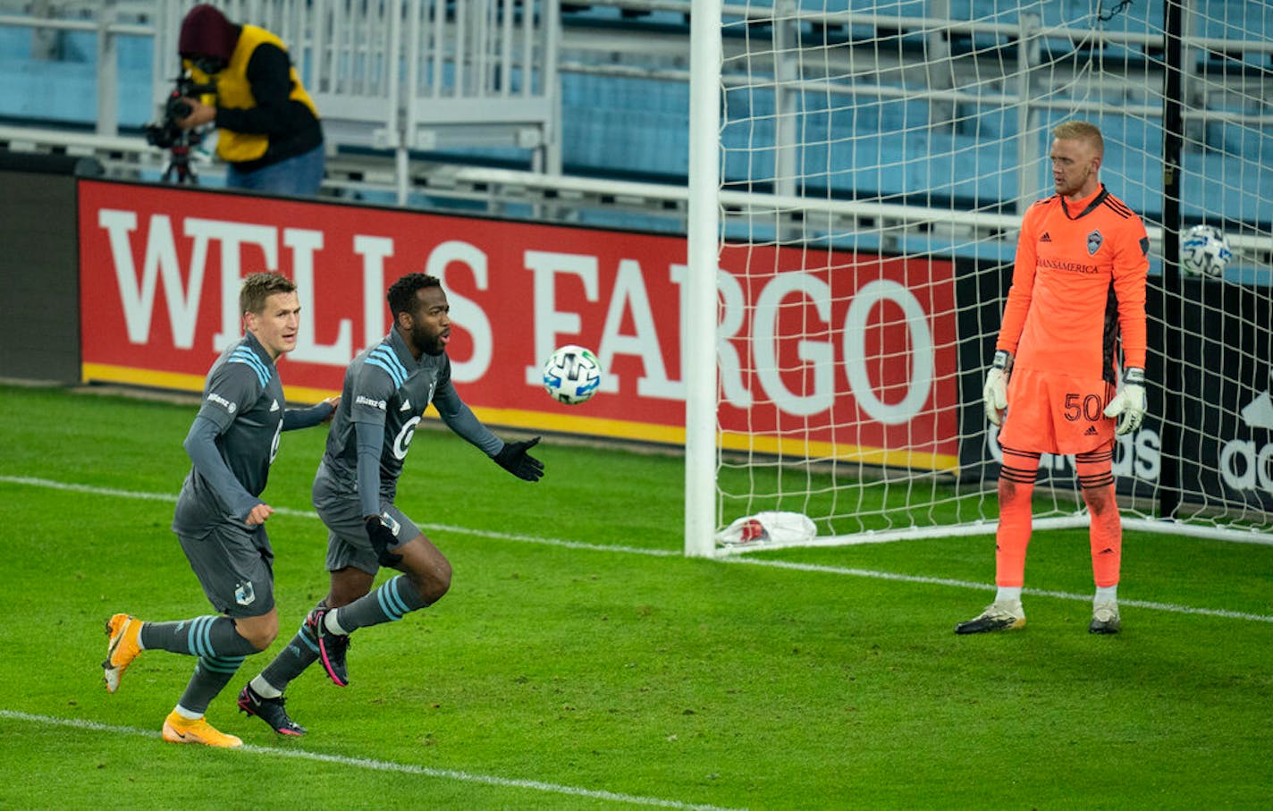 Minnesota United midfielder Kevin Molino (7) celebrated his first half goal with teammate midfielder Robin Lod (17) in front of Colorado Rapids goalkeeper William Yarbrough (50).