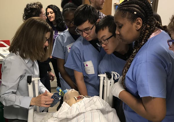 Registered nurses and staff teach high school students about caring for patients in a training room at Children&#xed;s Hospital in Minneapolis.