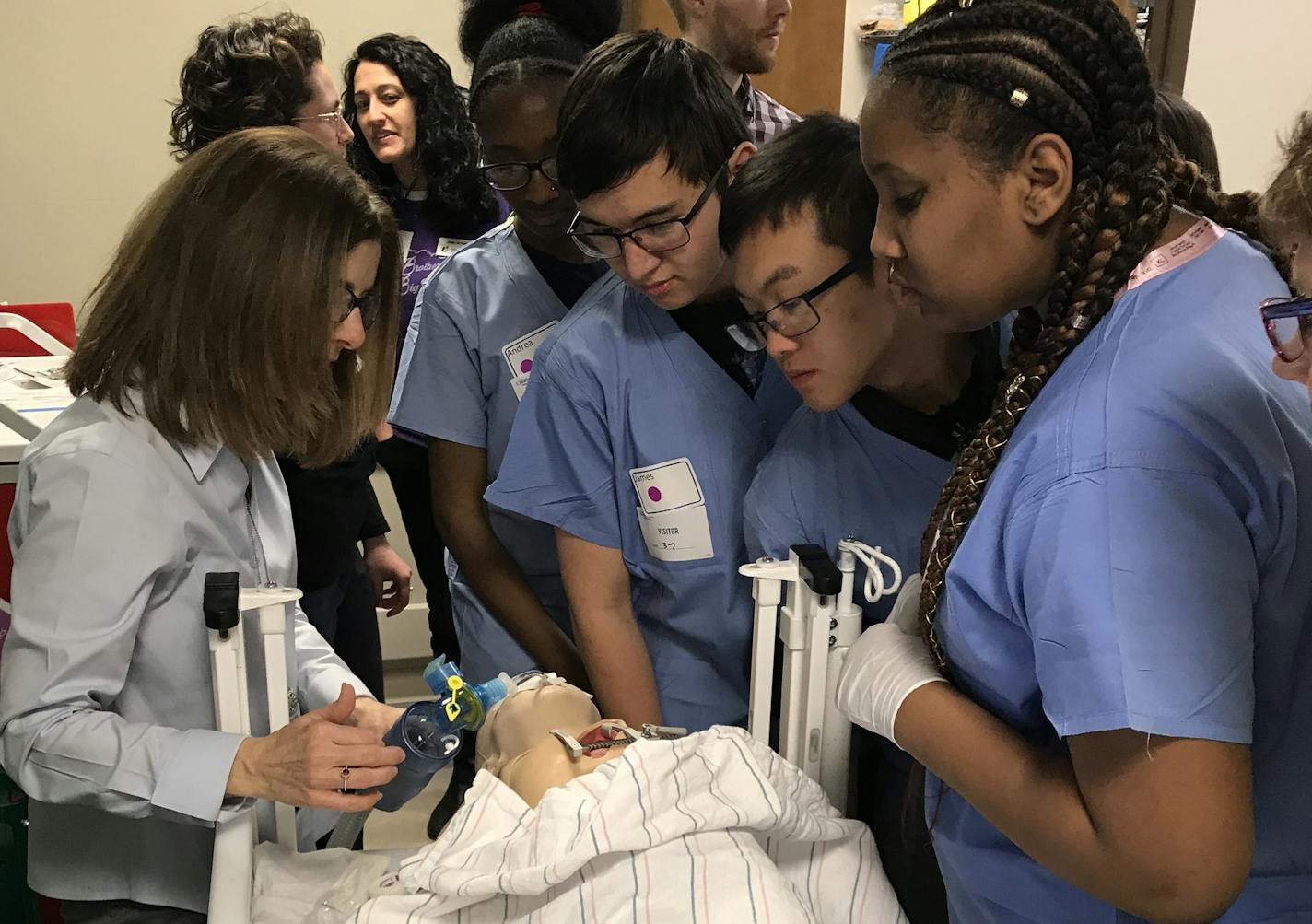 Registered nurses and staff teach high school students about caring for patients in a training room at Children&#xed;s Hospital in Minneapolis.