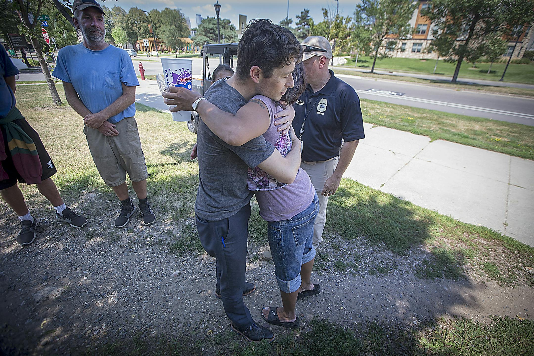 Minneapolis Mayor Jacob Frey gave Tiffany DeCoteau a hug as he visited a homeless encampment near 16th Avenue South & East Franklin Avenue along with Minneapolis Police Chief Medaria Arradondo and Minneapolis Police Sgt. Grant Snyder, Wednesday, August 8, 2018 in Minneapolis, MN.