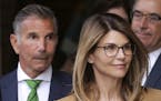 FILE - In this April 3, 2019 file photo, actress Lori Loughlin, front, and husband, clothing designer Mossimo Giannulli, left, depart federal court in