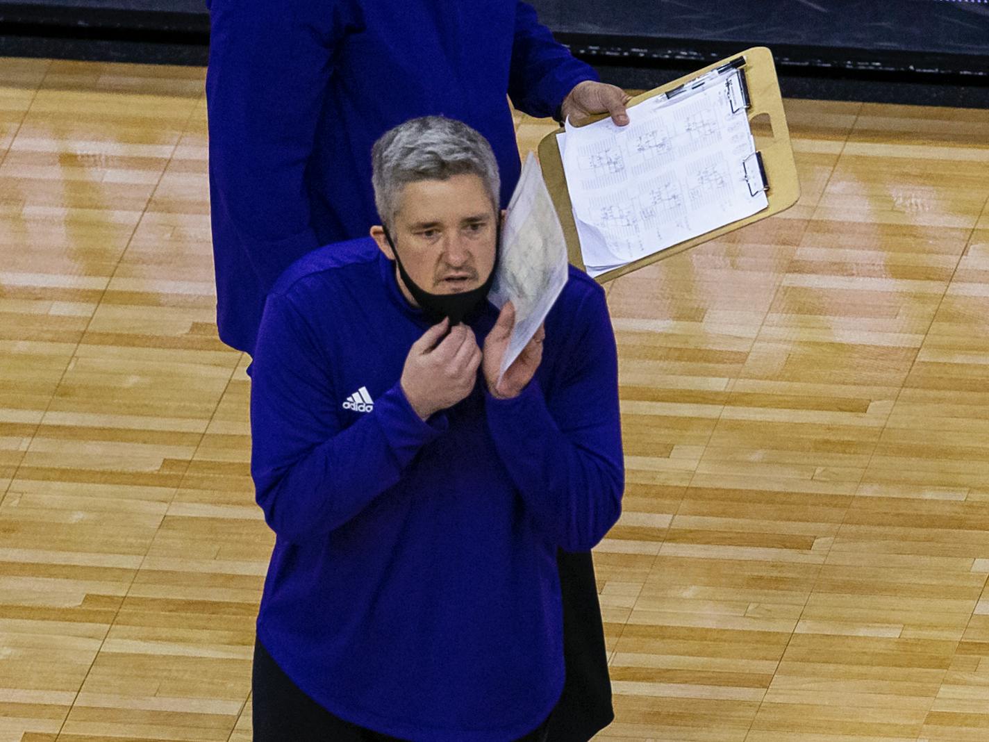 Washington head coach Keegan Cook talks to his player against Kentucky during a semifinal in the NCAA women's volleyball championships Thursday, April 22, 2021, in Omaha, Neb. (AP Photo/John Peterson)