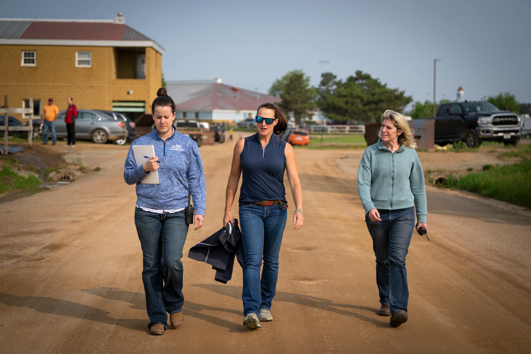 Veterinarians Dr. Rebecca Butler, from left, Dr. Jennifer McDonald, and Dr. Christy Klatt walk out to the barns to perform exams on horses that have not raced in 180 days or more at Canterbury Park in Shakopee, Minn.